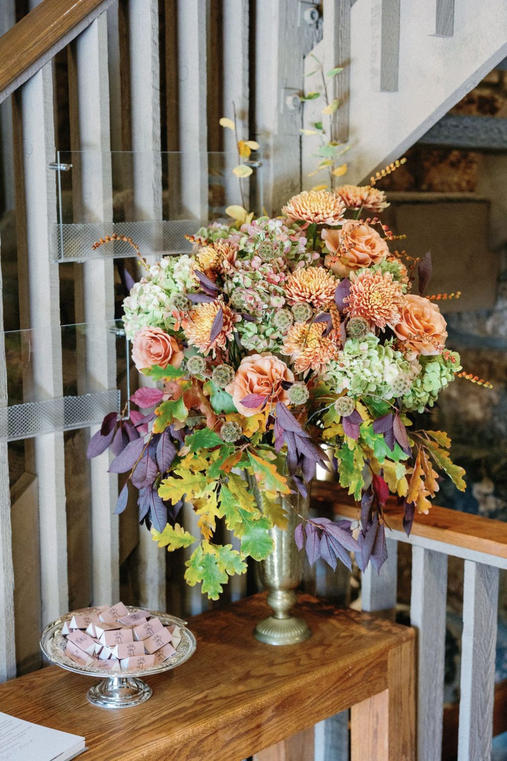 Kayla & Patrick's wedding at the Aspen Chapel and the Caribou Club: an arrangement of fall blooms in the chapel