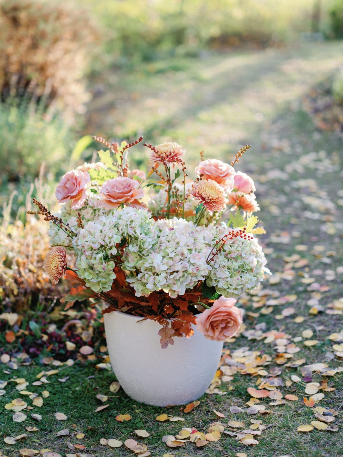 Kayla & Patrick's wedding at the Aspen Chapel and the Caribou Club: garden roses and hydrangea among fall leaves