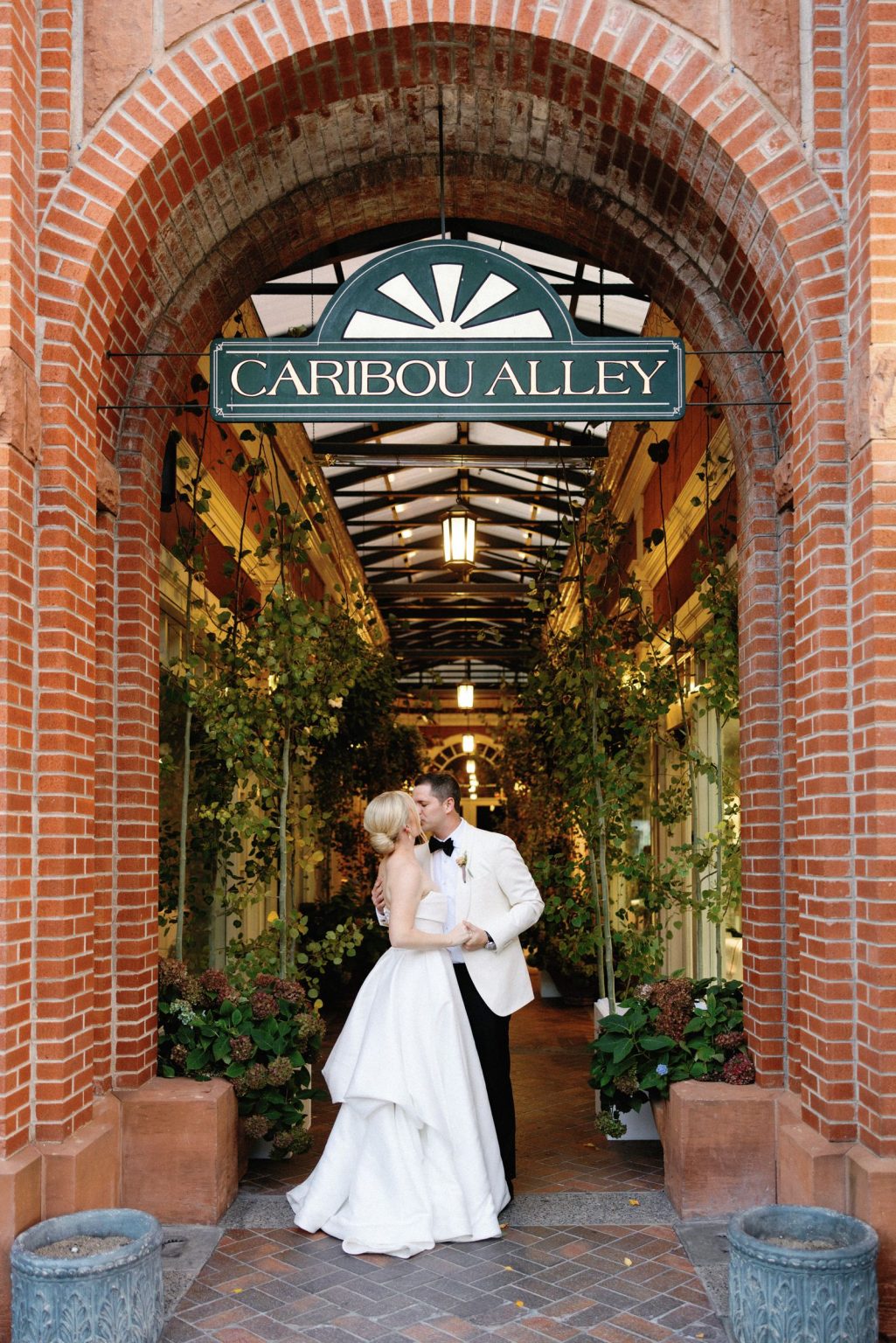 Kayla & Patrick's wedding at the Aspen Chapel and the Caribou Club: the couple beneath the Caribou Alley sign