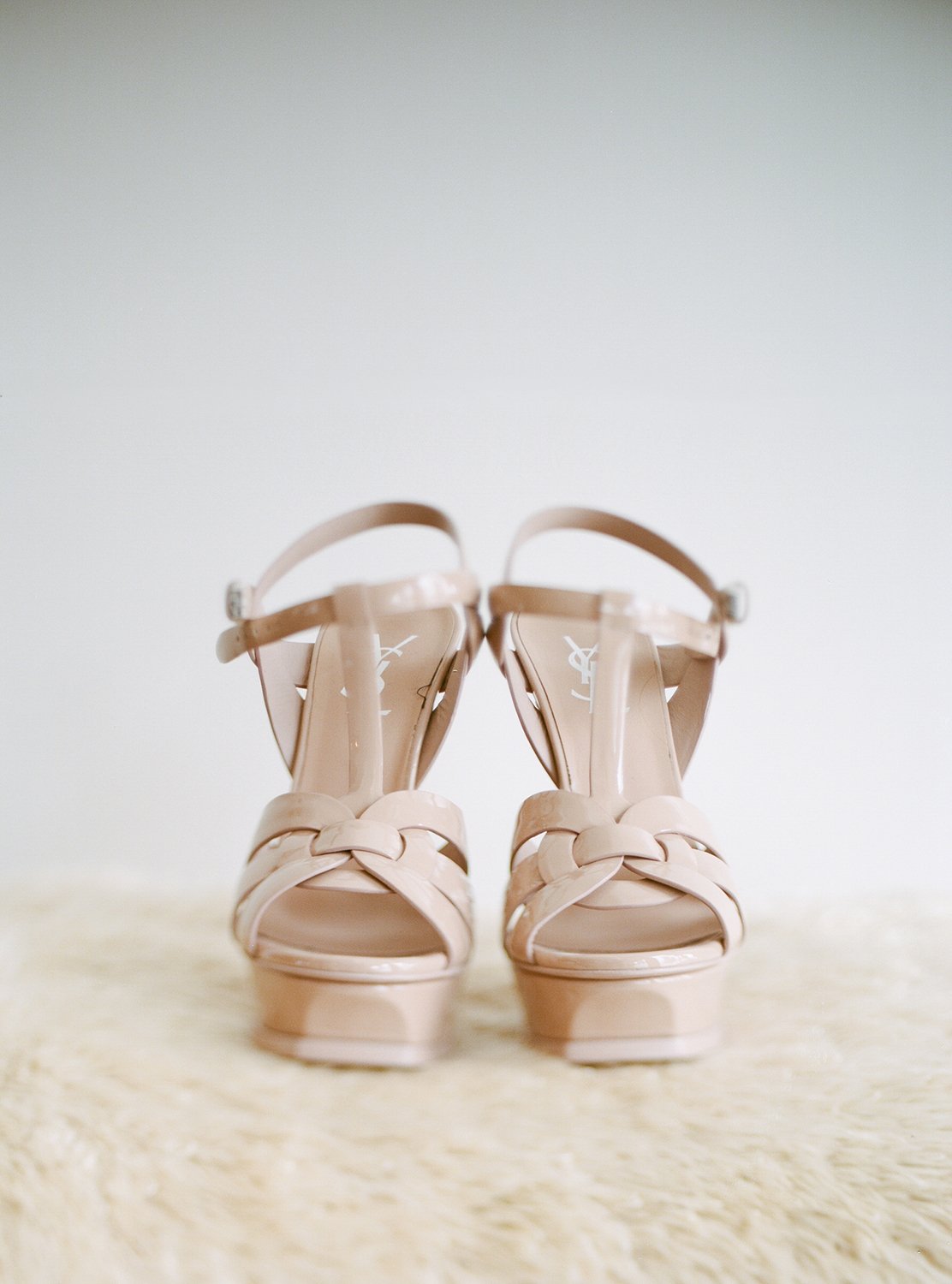 Coley & Teddy's wedding at the Aspen Chapel and Hotel Jerome: bridal shoes on sheepskin
