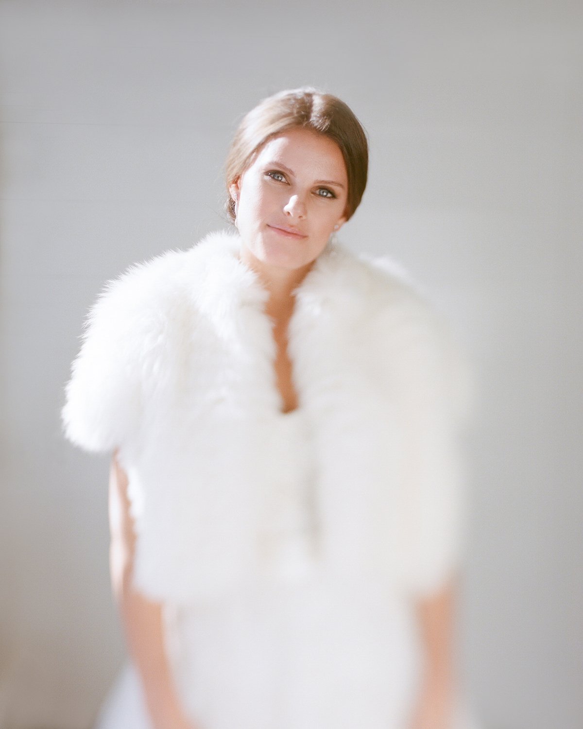 Coley & Teddy's wedding at the Aspen Chapel and Hotel Jerome: the bride in a fur wrap