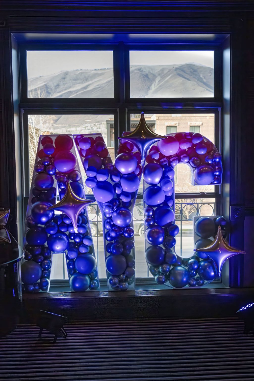 Wildest Dreams, the Aspen Youth Center gala at Hotel Jerome: mirrored disco-ball centerpieces in violet light