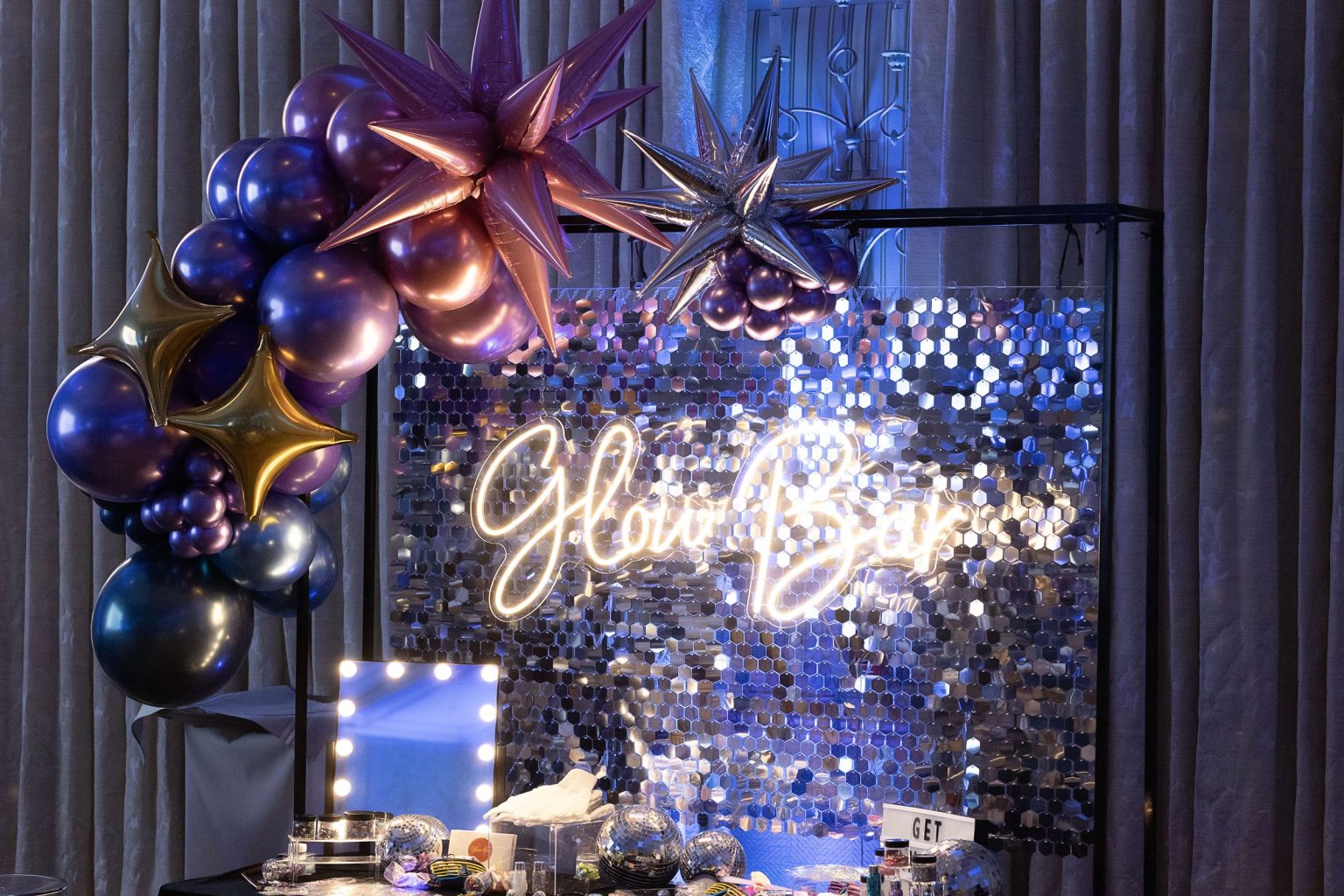 Wildest Dreams, the Aspen Youth Center gala at Hotel Jerome: the Glow Bar neon sign beneath balloon stars