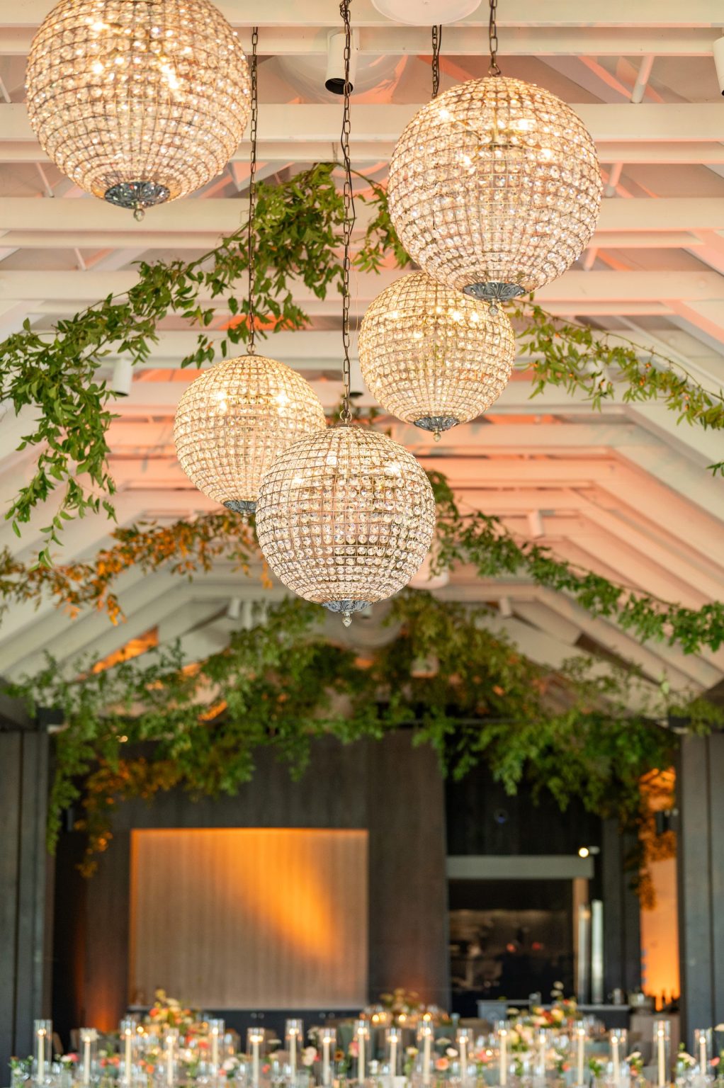 Haley and Sam's wedding at Buttermilk Mountain Lodge, Aspen: Crystal globe chandeliers hung with smilax