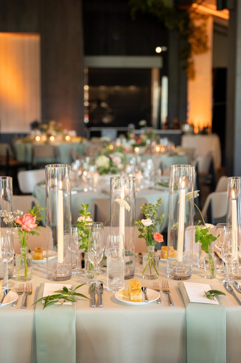 Haley and Sam's wedding at Buttermilk Mountain Lodge, Aspen: Tablescape with bud vases, tapers and sage napkins