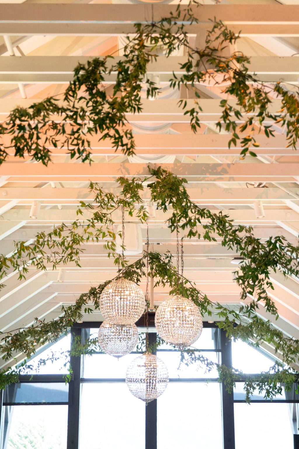 Haley and Sam's wedding at Buttermilk Mountain Lodge, Aspen: Smilax garlands draped across white rafters