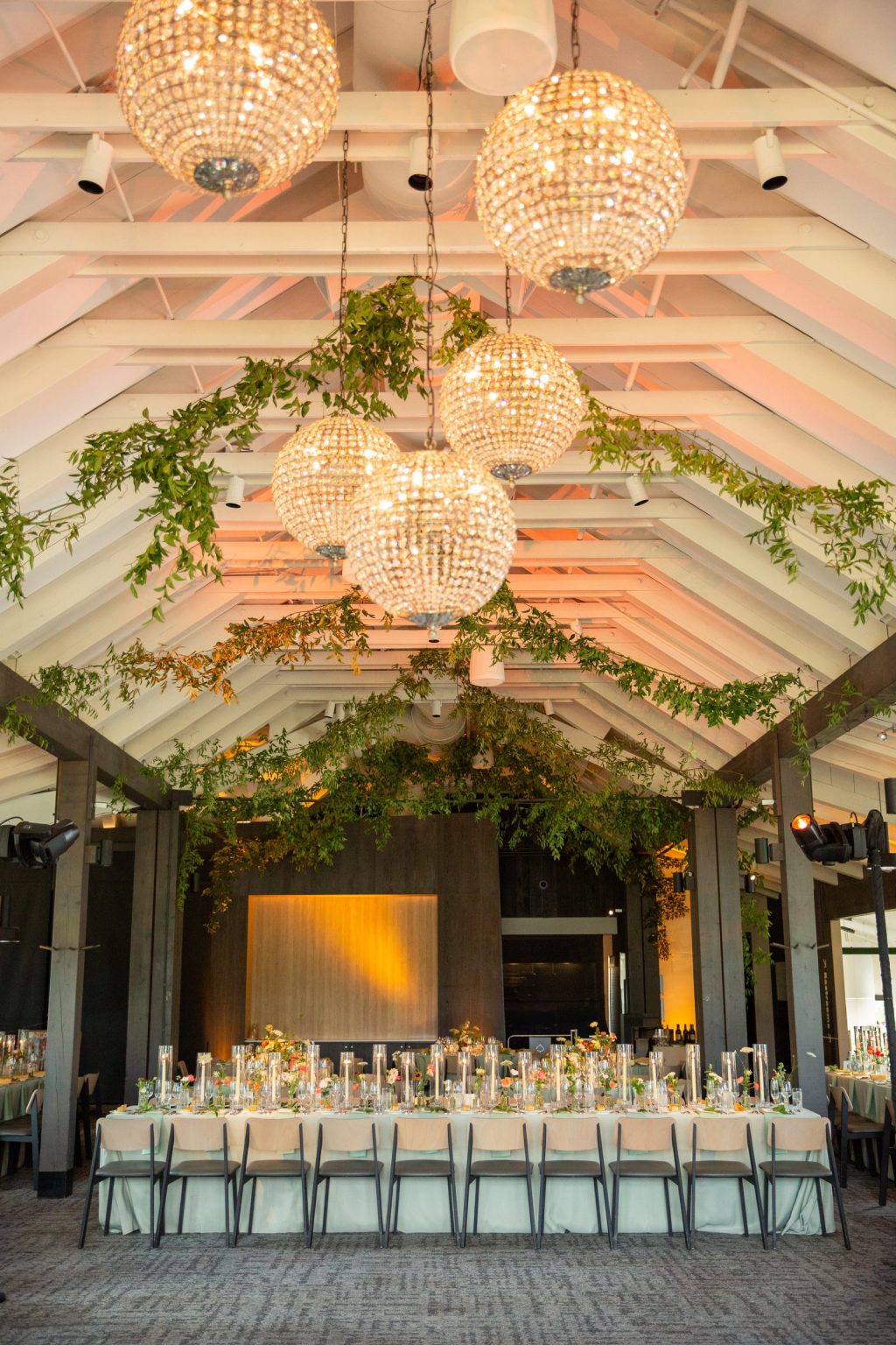 Haley and Sam's wedding at Buttermilk Mountain Lodge, Aspen: Crystal chandeliers above the long dinner table
