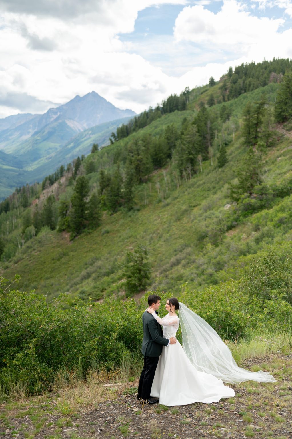 Haley and Sam's wedding at Buttermilk Mountain, Aspen: portrait on the mountainside with Pyramid Peak behind