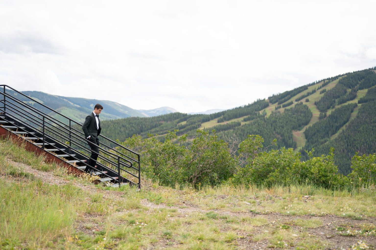 Haley and Sam's wedding at Buttermilk Mountain, Aspen: Sam heading down to the ceremony above the valley