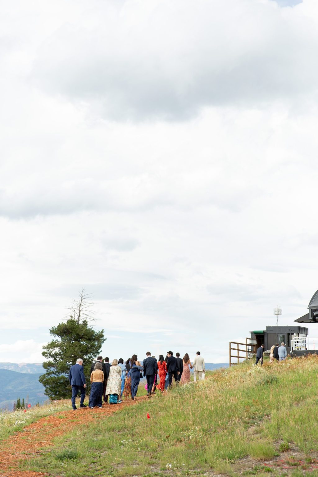 Haley and Sam's wedding at Buttermilk Mountain, Aspen: guests walking the ridge to the Cliffhouse