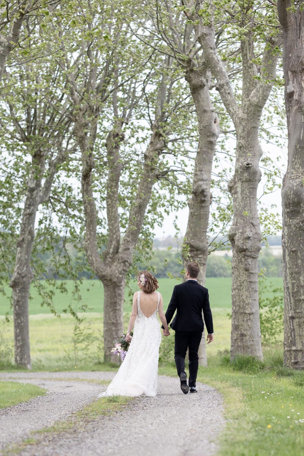 Château Saint Joseph FAM trip in the South of France: the couple walking the tree-lined allée