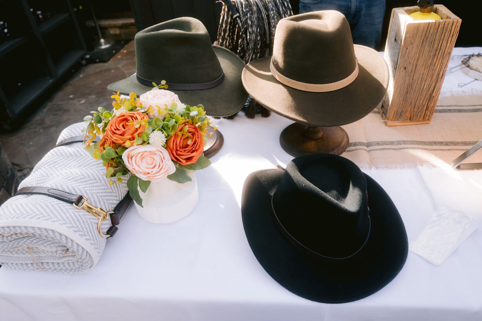 Addy & Nick's wedding at Hotel Jerome, Aspen: felt hats and florals at the hat bar