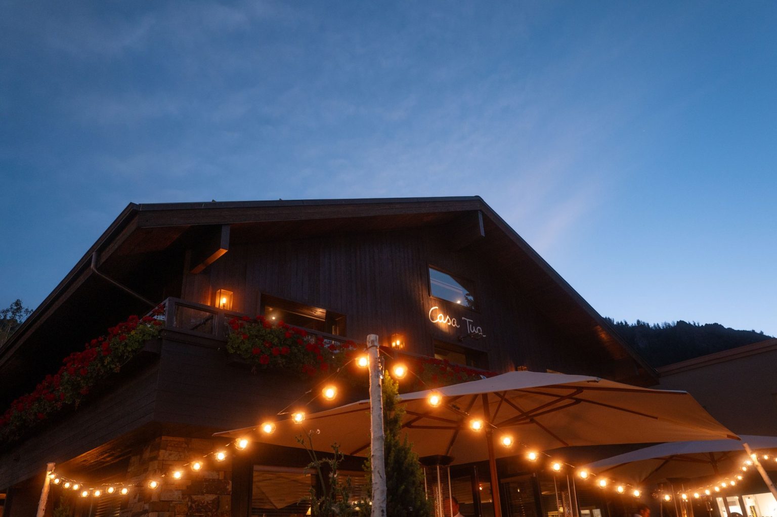 Addy & Nick's wedding at Hotel Jerome, Aspen: string lights at Casa Tua at dusk