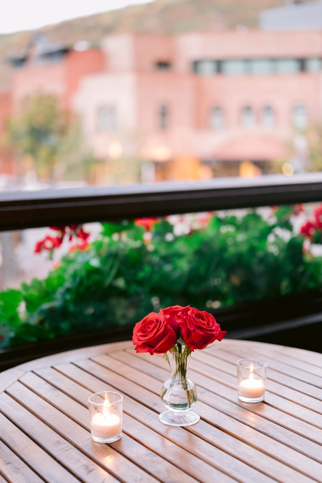 Addy & Nick's wedding at Hotel Jerome, Aspen: red blooms on the Casa Tua patio
