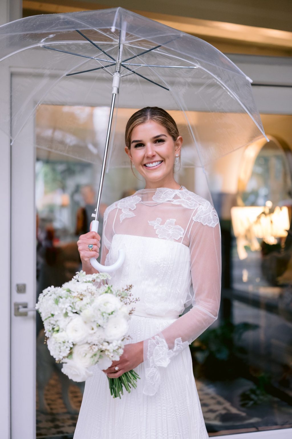 Addy & Nick's wedding at Hotel Jerome, Aspen: the bride under a clear umbrella