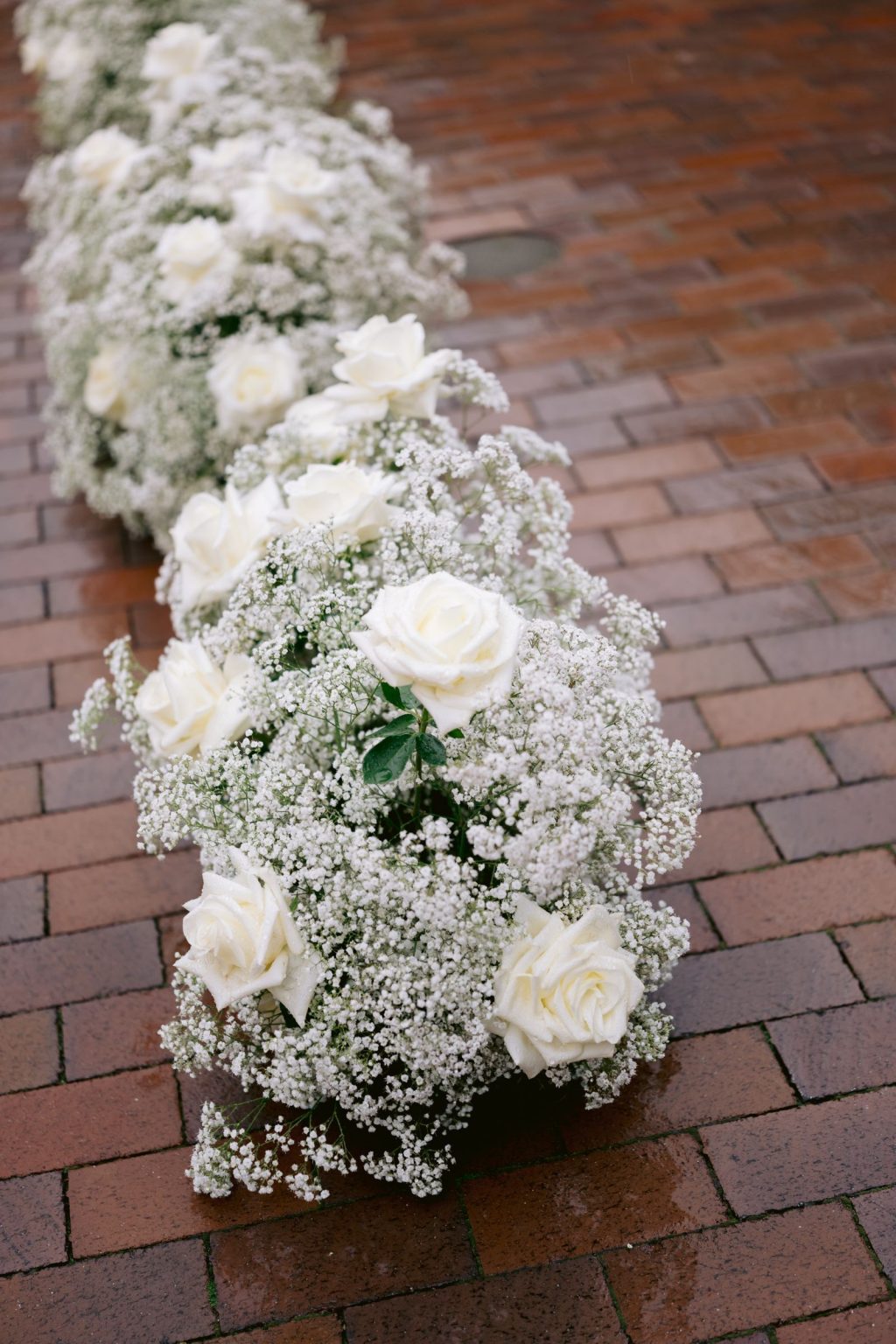 Addy & Nick's wedding at Hotel Jerome, Aspen: white florals lining the aisle