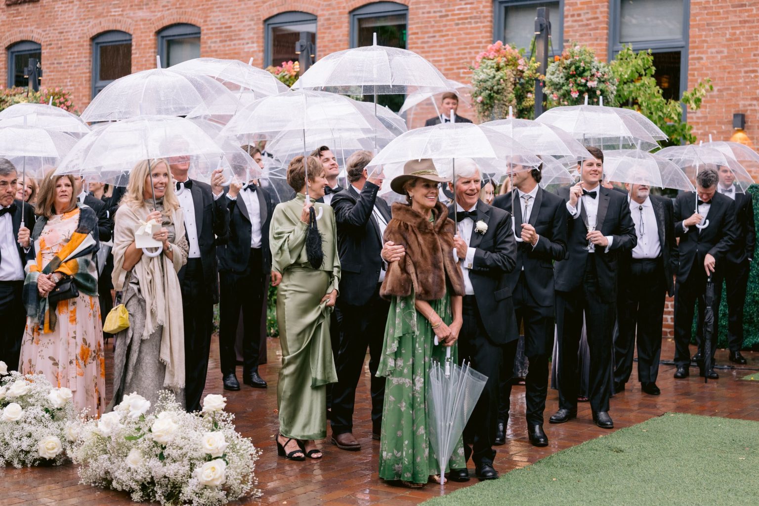 Addy & Nick's wedding at Hotel Jerome, Aspen: guests under clear umbrellas during the ceremony