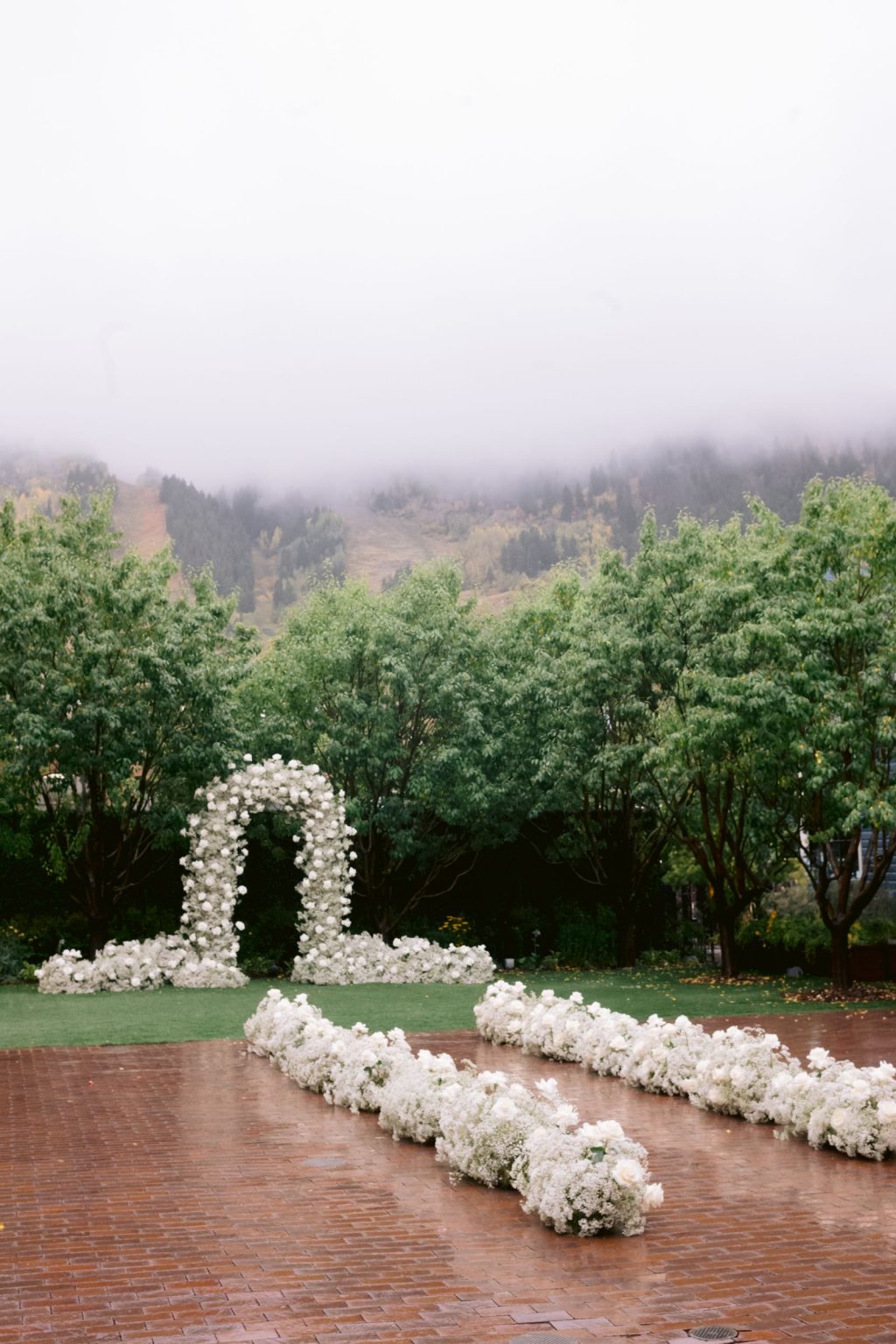 Addy & Nick's wedding at Hotel Jerome, Aspen: the white floral arch and aisle
