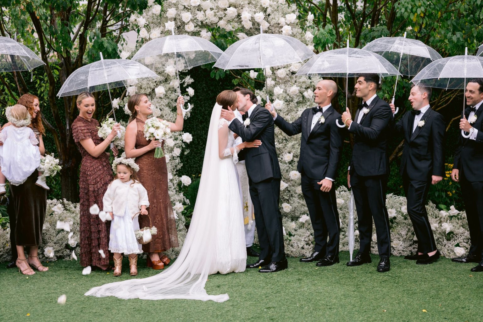 Addy & Nick's wedding at Hotel Jerome, Aspen: the kiss under the floral arch