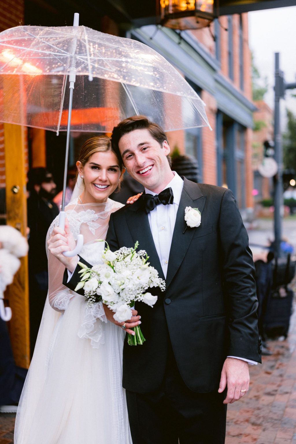 Addy & Nick's wedding at Hotel Jerome, Aspen: the couple under clear umbrellas