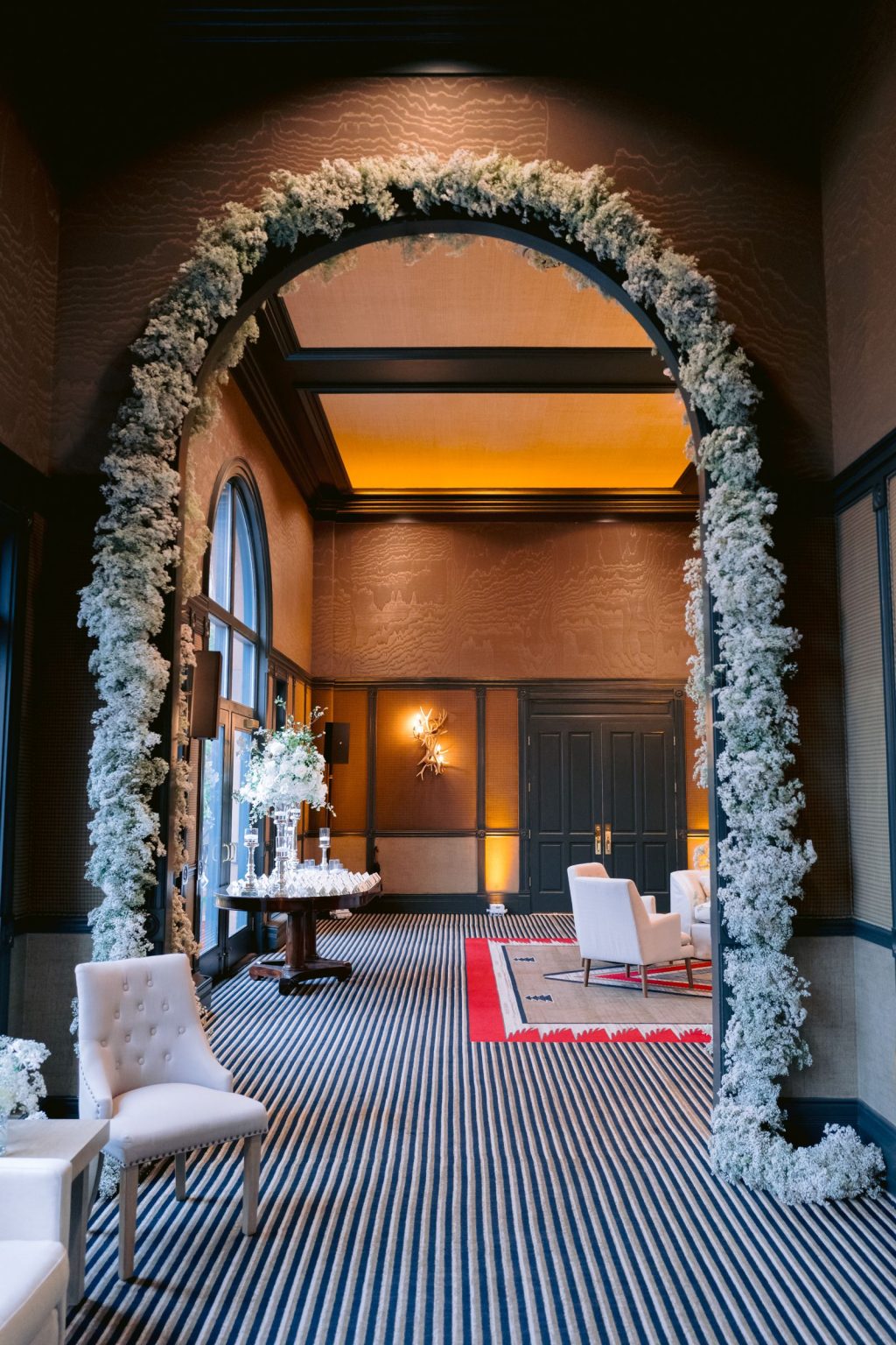 Addy & Nick's wedding at Hotel Jerome, Aspen: a white floral arch at the ballroom entrance