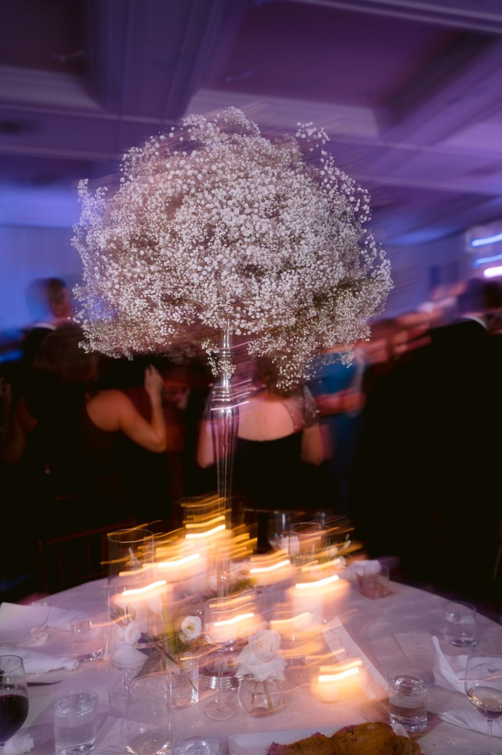 Addy & Nick's wedding at Hotel Jerome, Aspen: a baby's breath centerpiece by candlelight