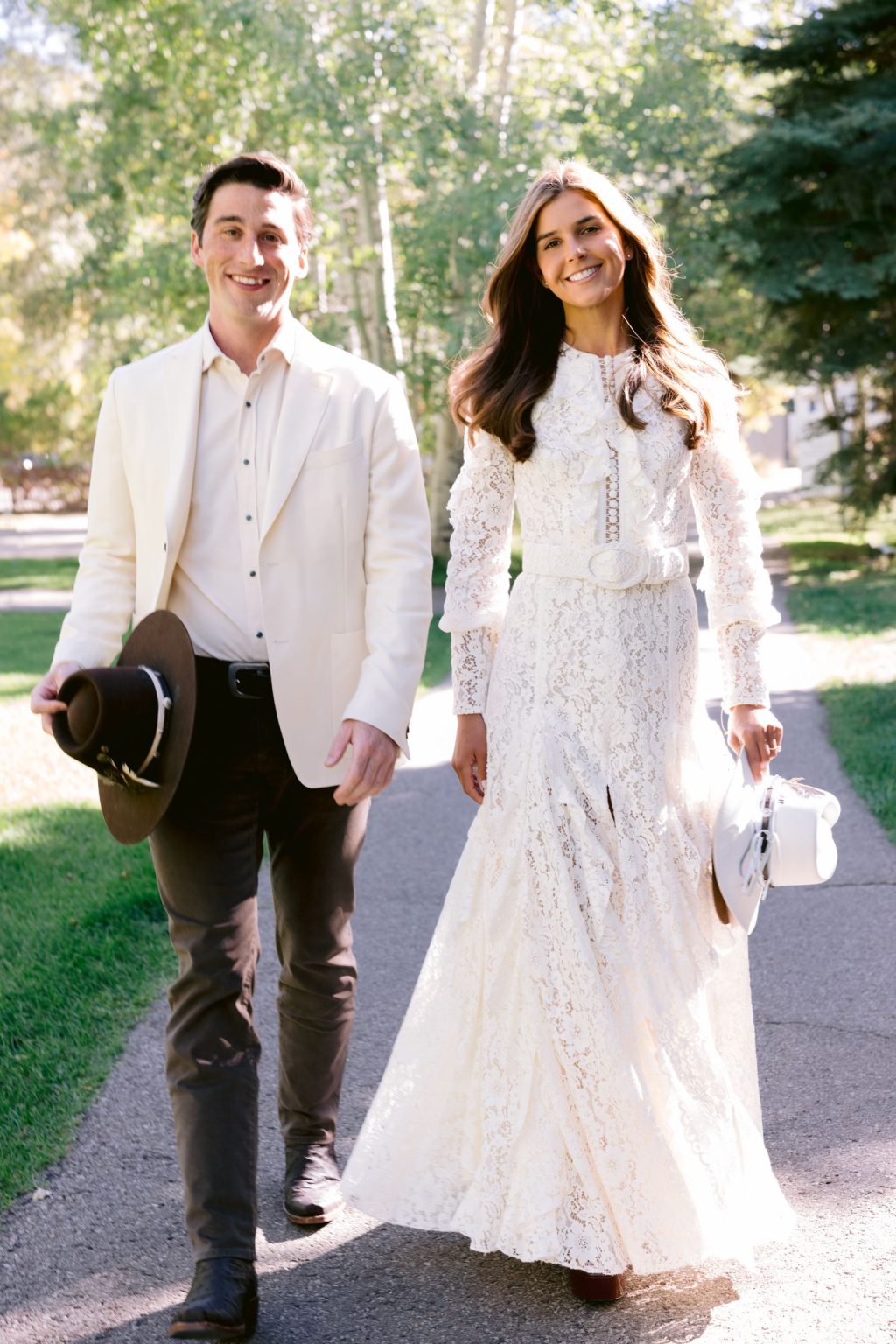 Addy & Nick's wedding at Hotel Jerome, Aspen: the couple in hats among the aspens