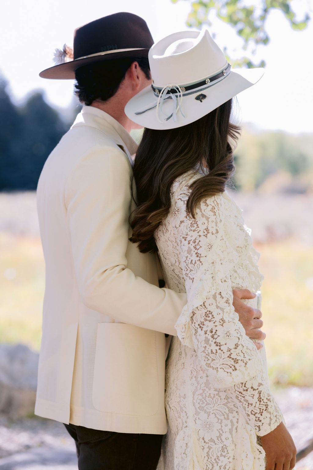 Addy & Nick's wedding at Hotel Jerome, Aspen: the couple in matching cream and hats
