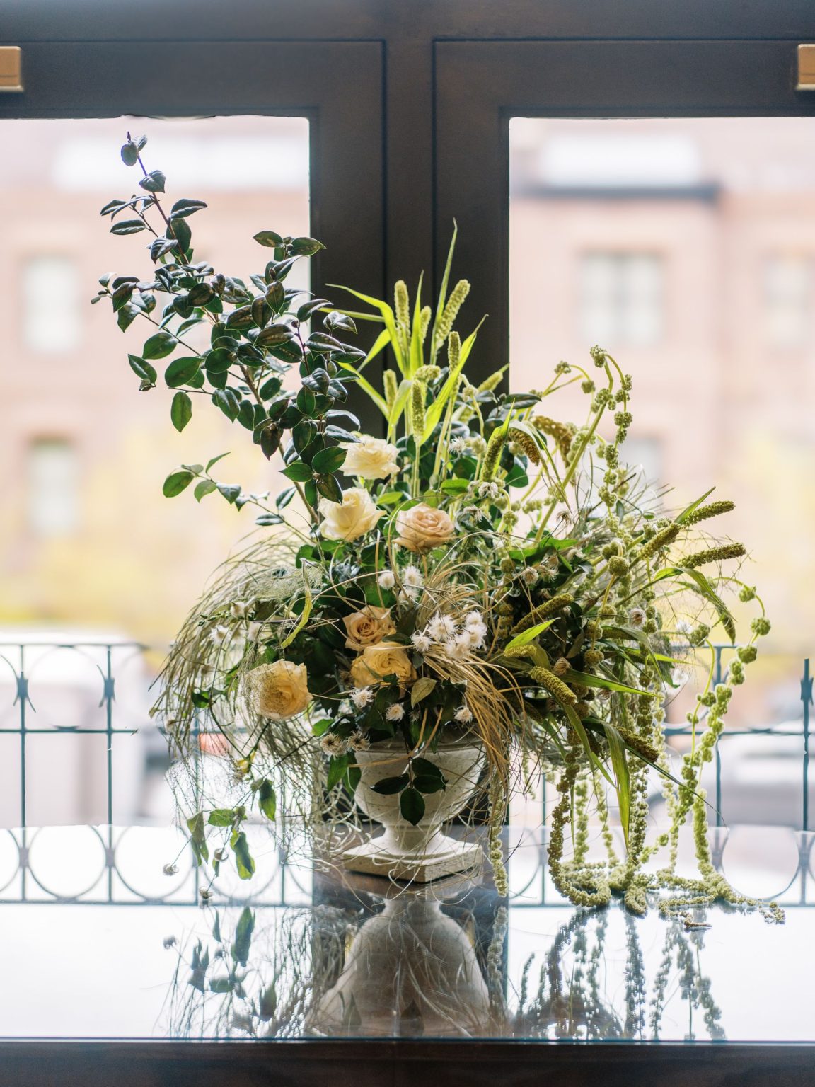 Abby & David's wedding at Hotel Jerome, Aspen: an arrangement against the arched windows