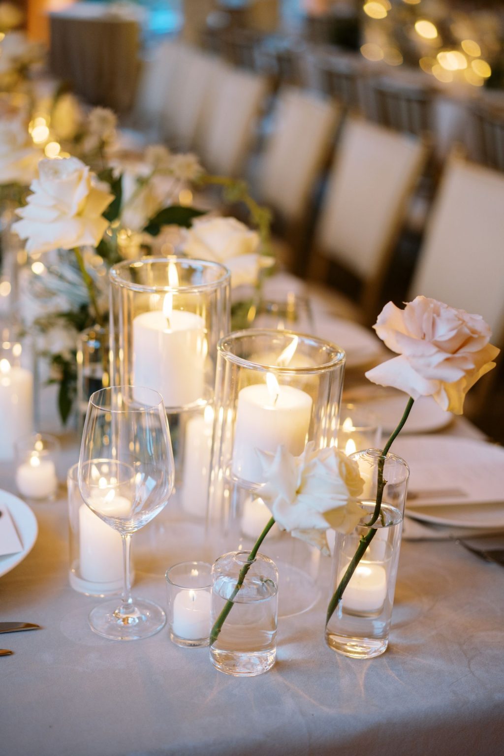 Abby & David's wedding at Hotel Jerome, Aspen: candles and white blooms on the table