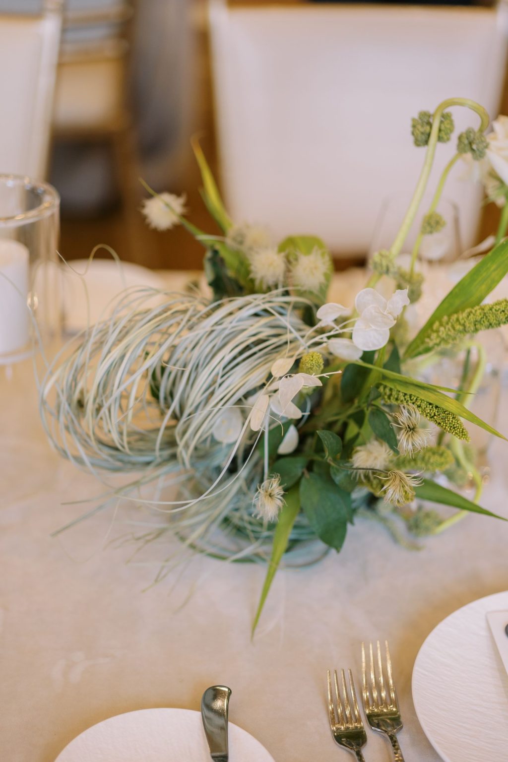 Abby & David's wedding at Hotel Jerome, Aspen: orchids and grasses in a low nest arrangement