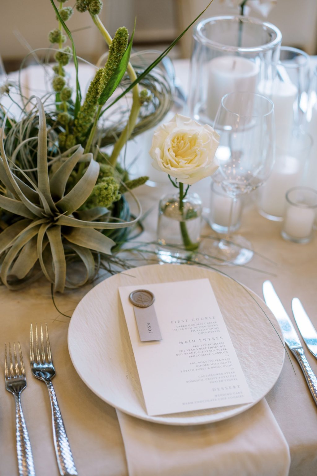 Abby & David's wedding at Hotel Jerome, Aspen: an air plant arrangement beside the menu