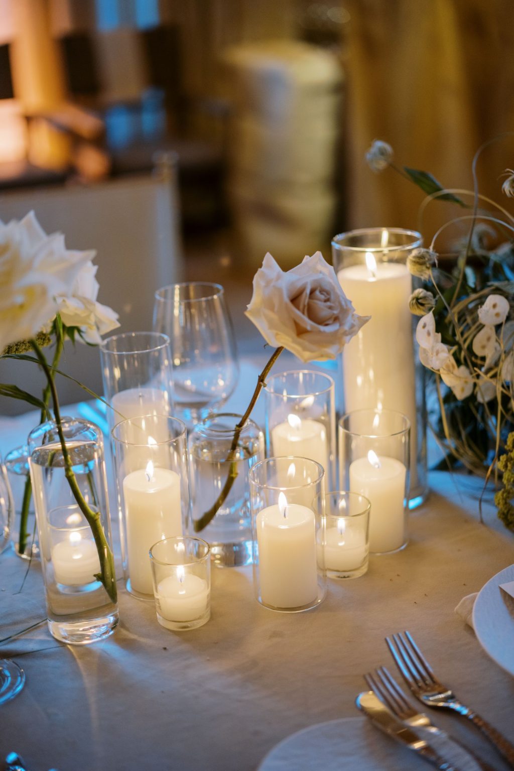 Abby & David's wedding at Hotel Jerome, Aspen: roses and candles in glass