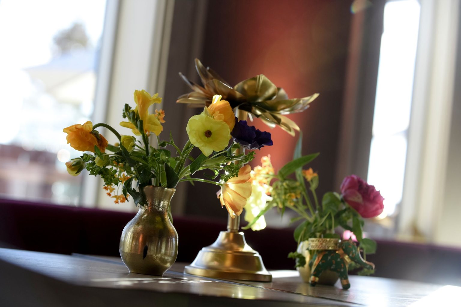 Jeff's 60th birthday on Aspen Mountain: bright florals in gold bud vases in the Aspen Mountain Club