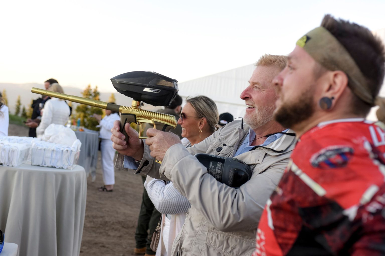 Jeff's 60th birthday on Aspen Mountain: guests lining up for paintball on the lawn