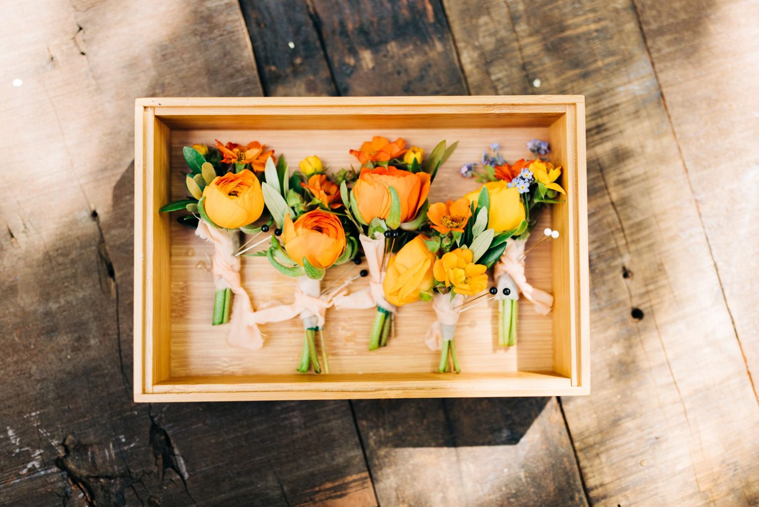 Julie & Tobias's wedding on the Northstar Preserve, Aspen: boutonnieres in a wooden box