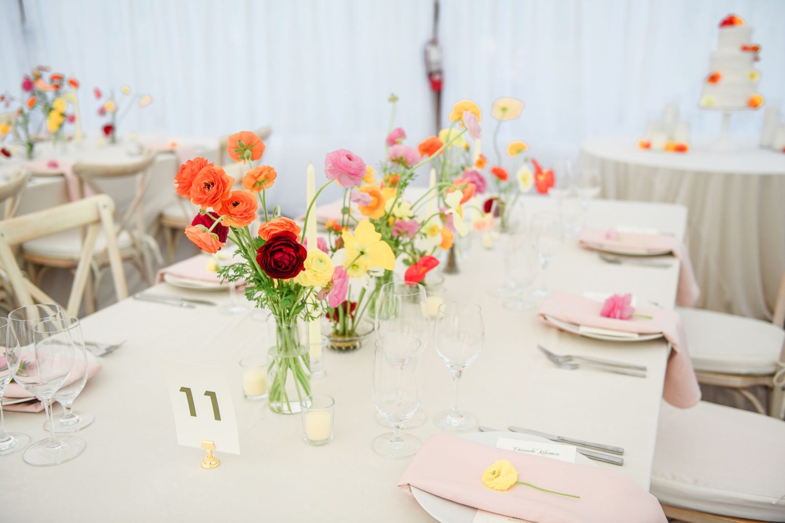 Julie & Tobias's wedding on the Northstar Preserve, Aspen: a reception table with bud vases of poppies and ranunculus