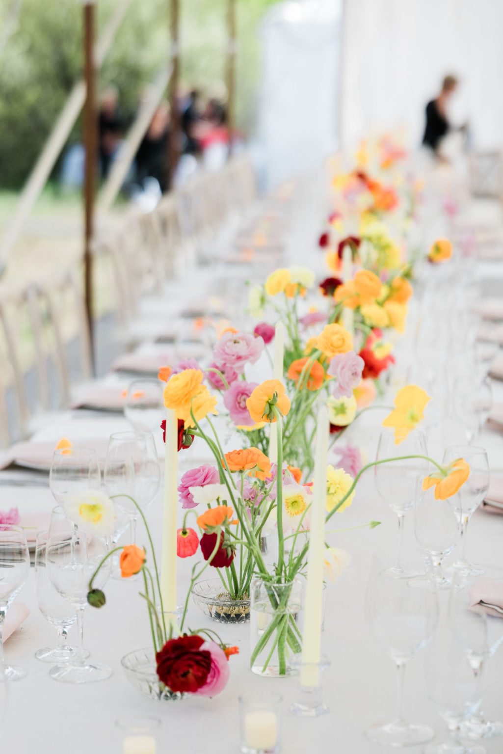 Julie & Tobias's wedding on the Northstar Preserve, Aspen: a long table lined with spring blooms