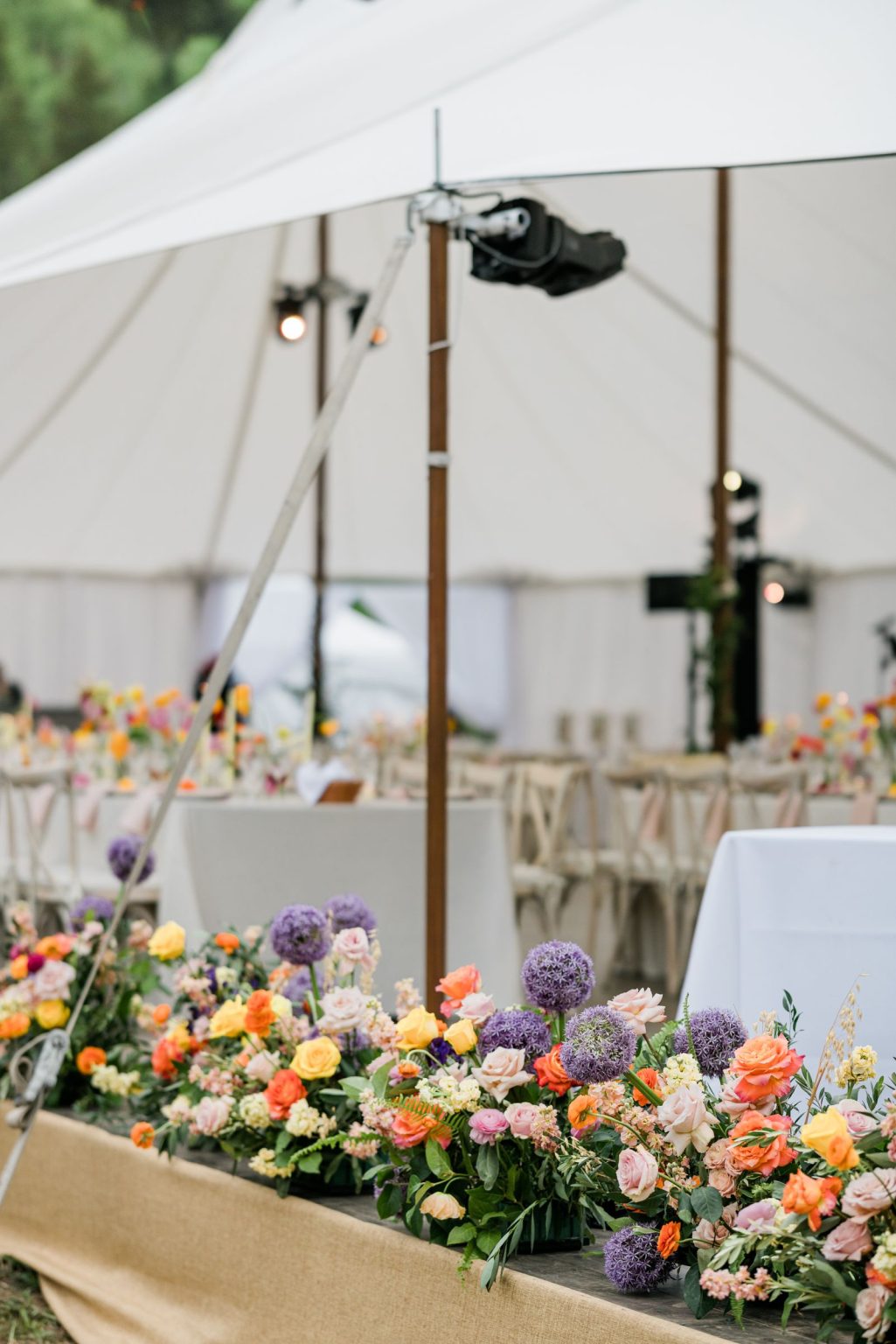 Julie & Tobias's wedding on the Northstar Preserve, Aspen: the flower-lined stage in the tent