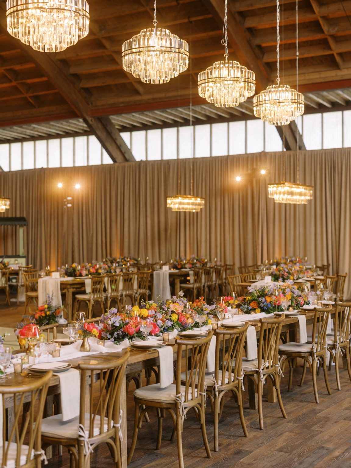 Clare and Kobe's McCabe Ranch wedding in Old Snowmass, Colorado: crystal chandeliers over the dinner tables