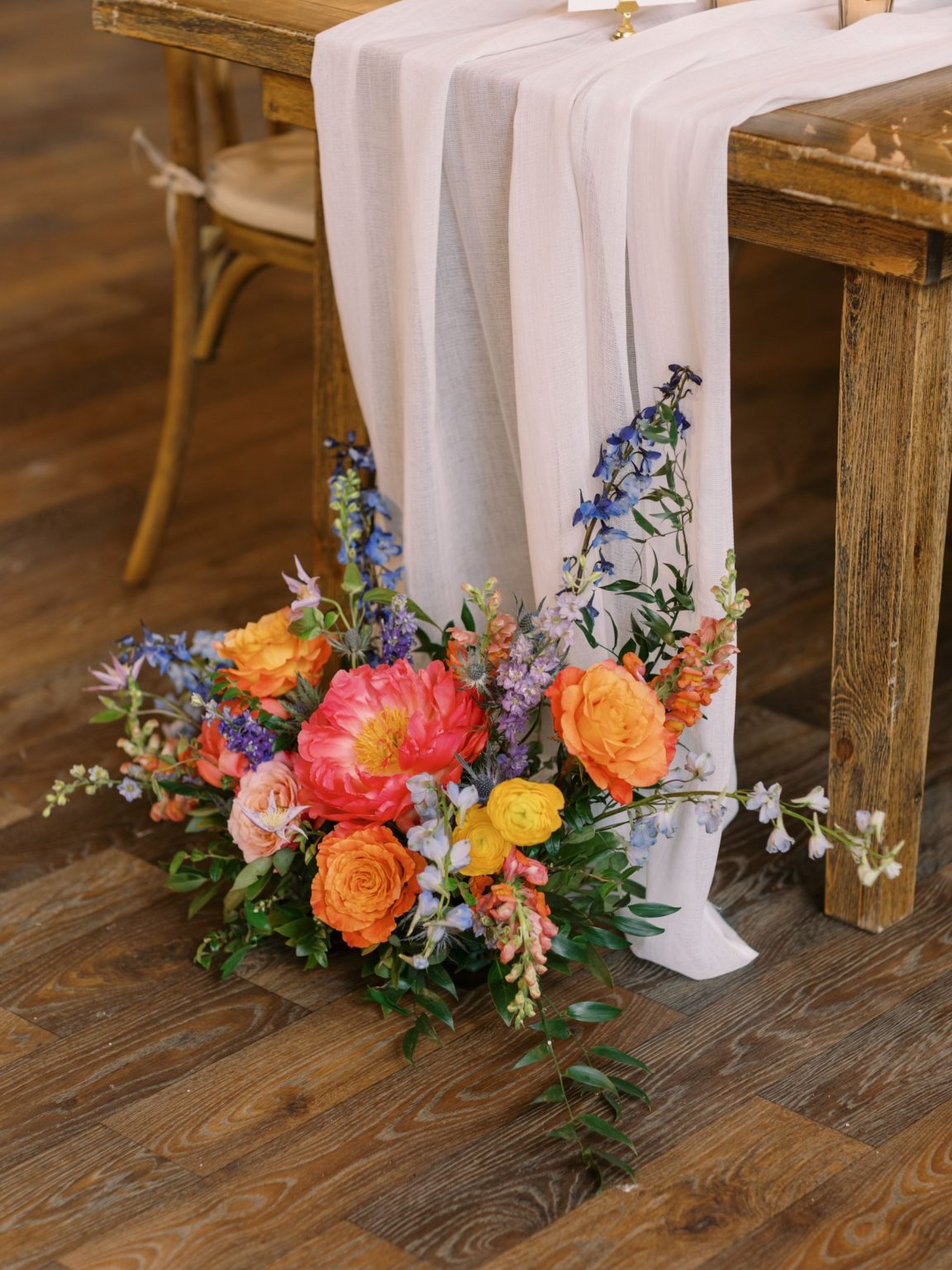 Clare and Kobe's McCabe Ranch wedding in Old Snowmass, Colorado: long table with a floor arrangement