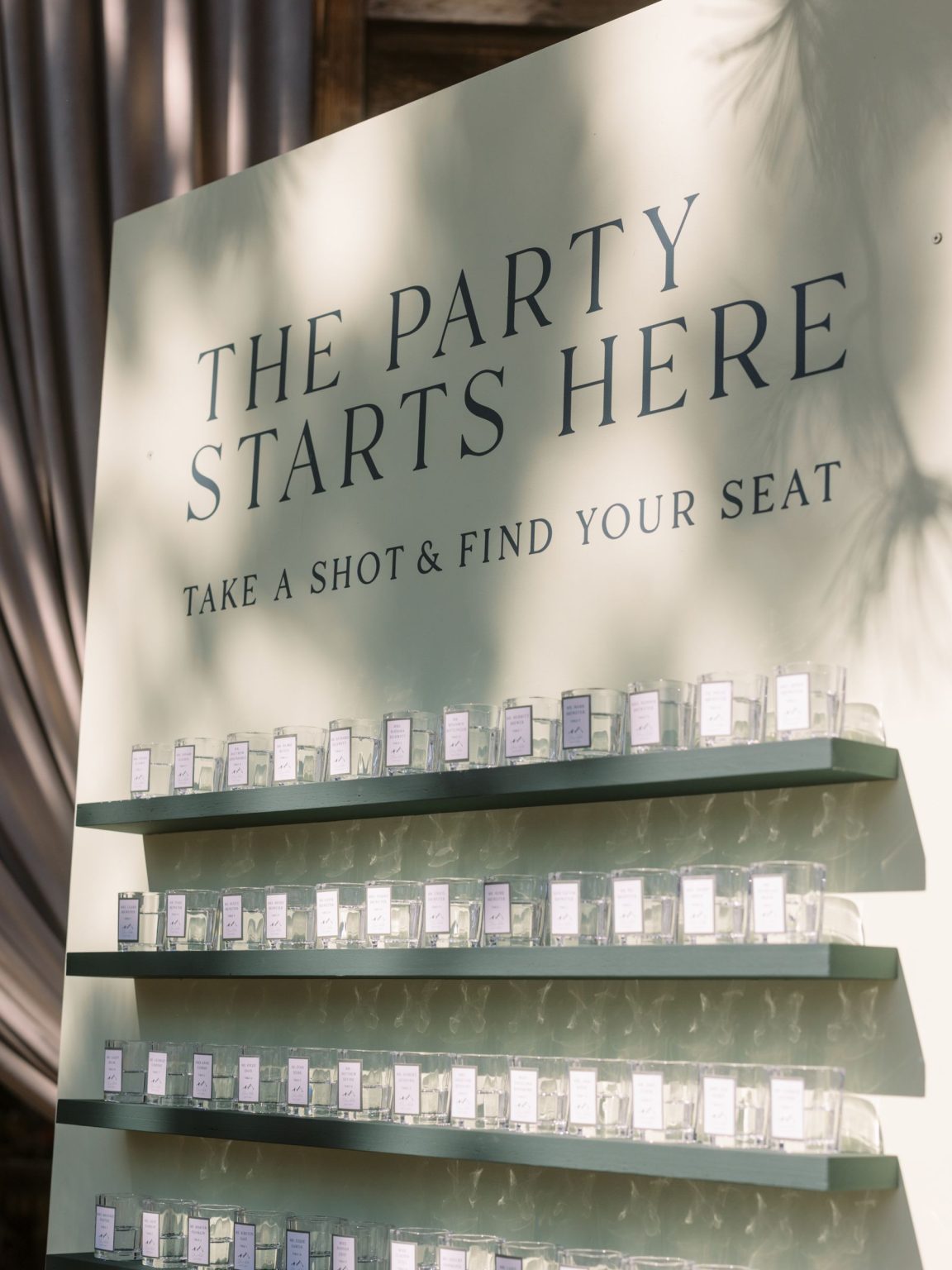 Clare and Kobe's McCabe Ranch wedding in Old Snowmass, Colorado: Carta Blanc seating sign above the shot-glass escort wall