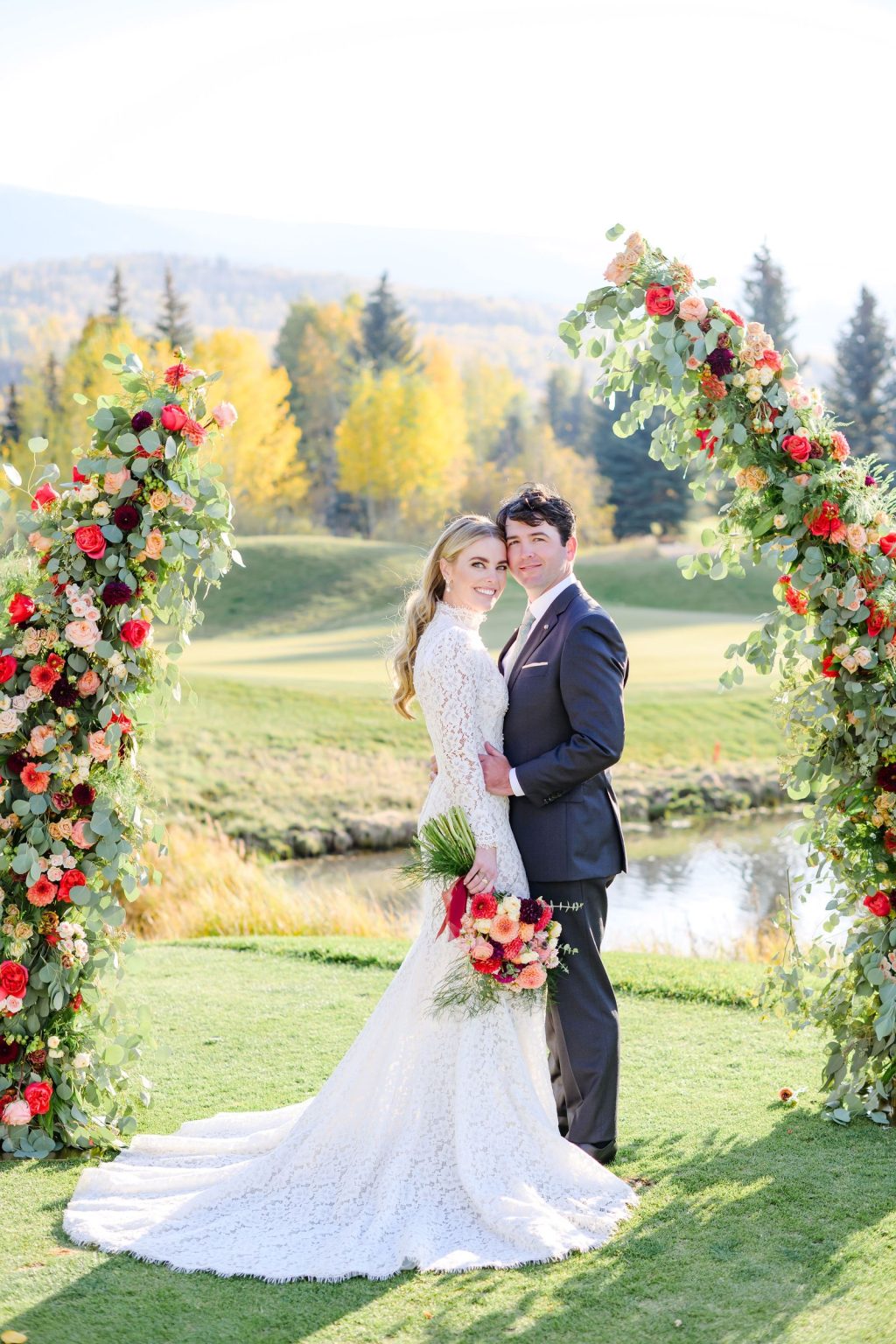 Ryann and Cole's wedding at the Snowmass Club, Snowmass Village: the couple beneath the floral arches