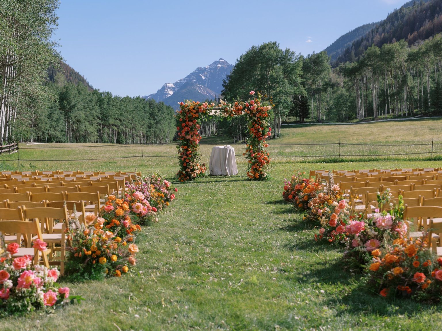 A summer wedding at T Lazy 7 Ranch, Aspen: the ceremony aisle in the meadow