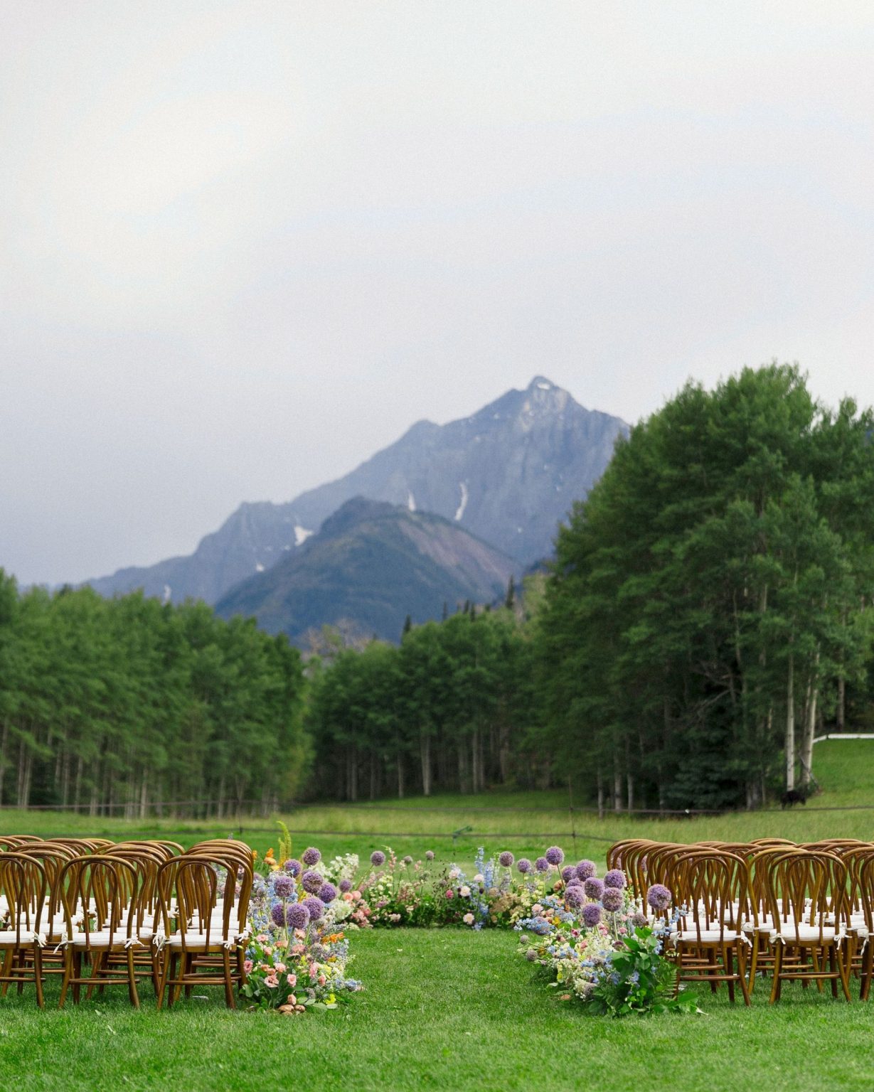 A wildflower wedding at T Lazy 7 Ranch, Aspen: the ceremony circle in the valley beneath the peaks