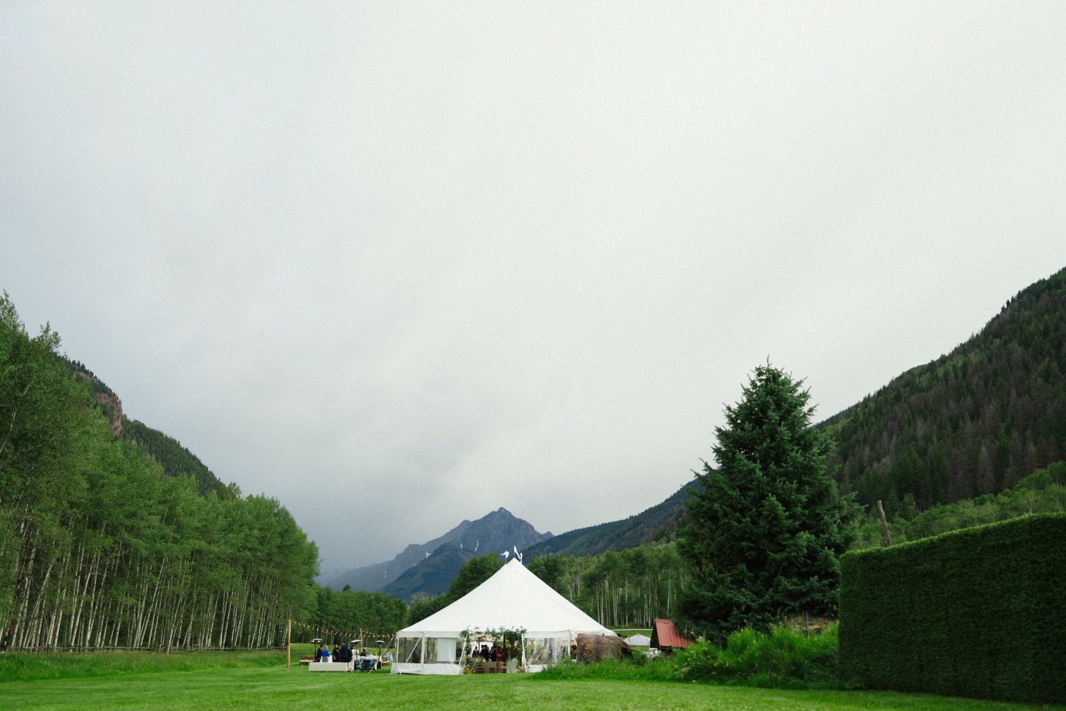 A wildflower wedding at T Lazy 7 Ranch, Aspen: the sailcloth tent in the valley below the mountains