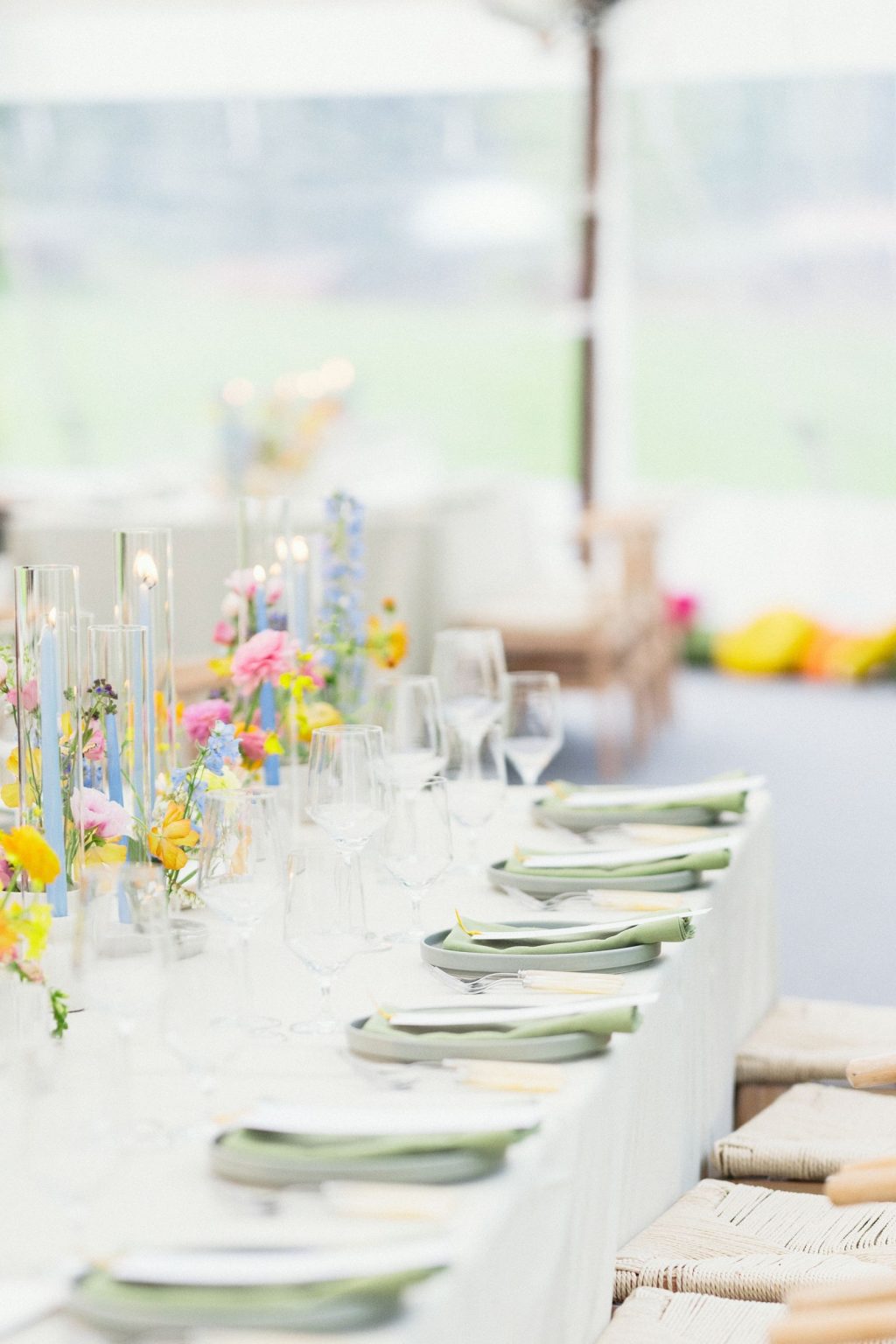A wildflower wedding at T Lazy 7 Ranch, Aspen: long tables set with bud vases and pale blue tapers