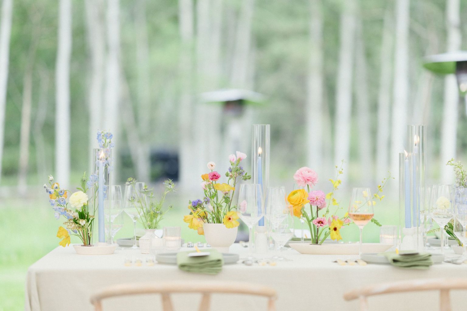 A wildflower wedding at T Lazy 7 Ranch, Aspen: a long table set against the aspen grove