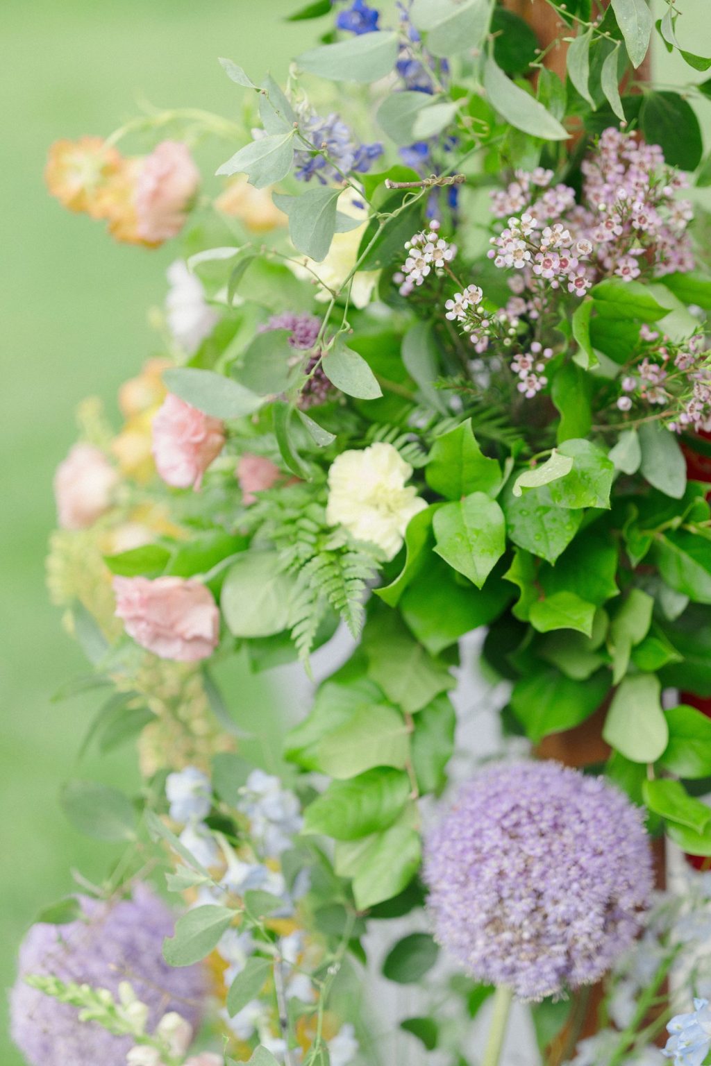 A wildflower wedding at T Lazy 7 Ranch, Aspen: garden roses, allium, and greenery climbing the tent entrance