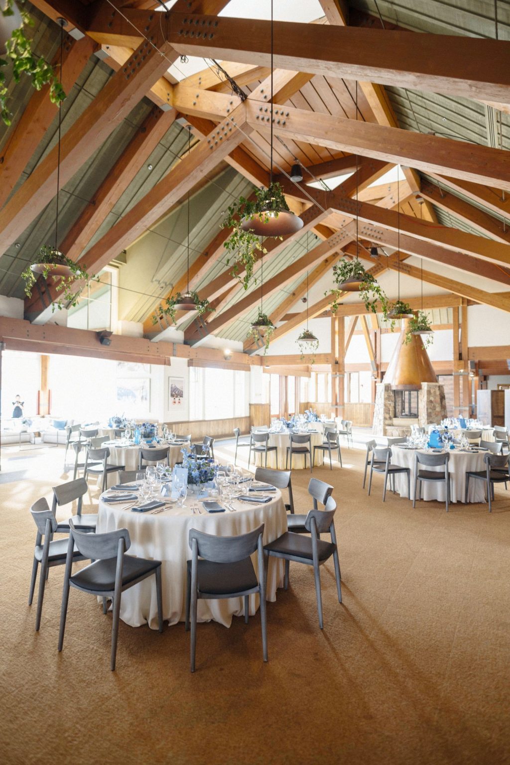 A wildflower wedding at T Lazy 7 Ranch, Aspen: the rehearsal dinner room at The Little Nell under its timber beams
